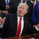 President Trump makes gestures in the Oval Office on March 21, 2017 to show that if humans really wanted to get to the moon all they needed to do was move their arms like this (Photo by Alex Wong/Getty Images)